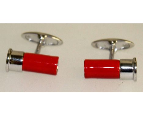 A pair of sterling silver and enamel cufflinks in the form of shotgun cartridges.