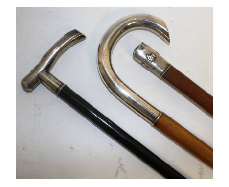 Three Chinese silver handled walking sticks.