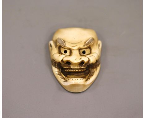 An ivory Kurohige mask netsuke, by HiroyukiJapan, Edo period (1603-1868) 19th centuryA mask representing a dragon god which i