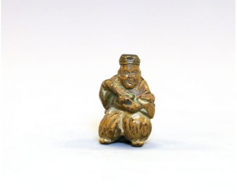 A wood Netsuke of a Chajin preparing teaJapan, Edo period (1603-1868) 19th centuryCarved seated on a barrel, holding a bowl a