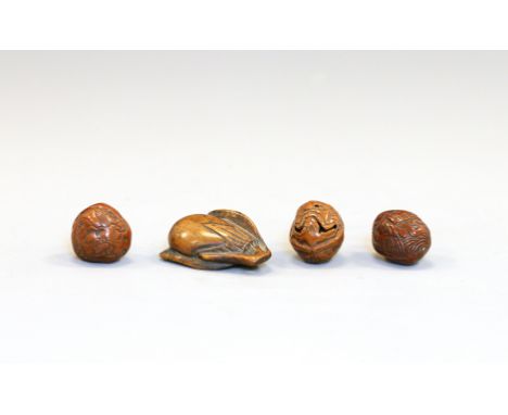 Four wood NetsukeJapan, Edo period (1603-1868) 19th centuryConsisting of three carved walnut netsuke and an eggplant netsuke.
