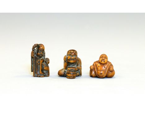 Three wood NetsukeJapan, Edo period (1603-1868) 18th/19th centuryConsisting of a carving of Fukurokuju with a young boy holdi