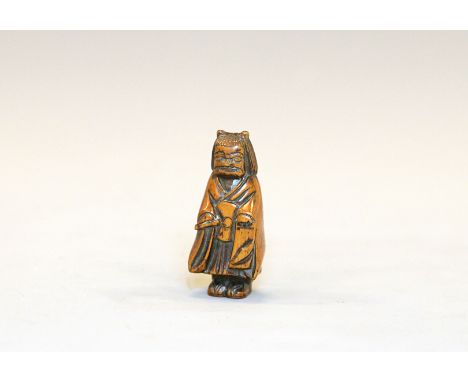 A wood netsuke of an Oni begging for almsJapan, Edo period (1603-1868) first half 19th centuryFinely carved Standing, facing 