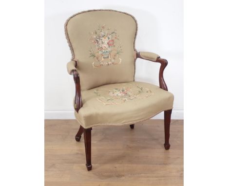 A 19th Century mahogany Elbow Chair, the upholstery with embroidery of baskets of flowers, having shaped arms and step fluted