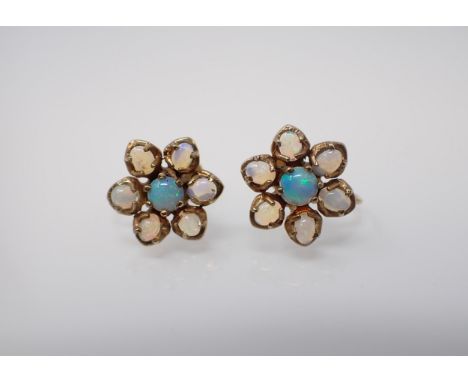 A pair of Opal Flower Cluster Earrings claw-set round cabochon within frame of six oval cabochons on screw fittings stamped 9