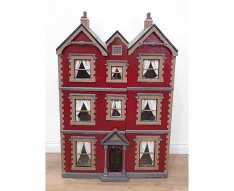 An Art Nouveau Doll's House with unusual triple gable roof, the front opening in two sections to reveal the six rooms all hav