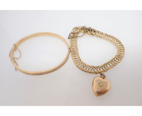 A 9ct gold hinged Bangle the front with scroll engraving and a fine link Bracelet with heart charm on hidden clasp, approx 30