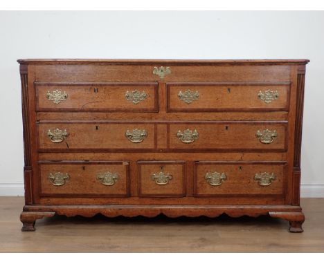 A 19th Century oak Lancashire Chest with crossbanded hinged top above two dummy drawers above one long and three small drawer