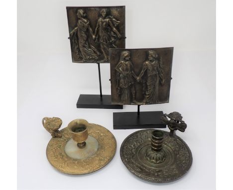 A pair of French bronze Plaques on stands embossed classical figures a late 18th Century French bronze Chamberstick embossed 