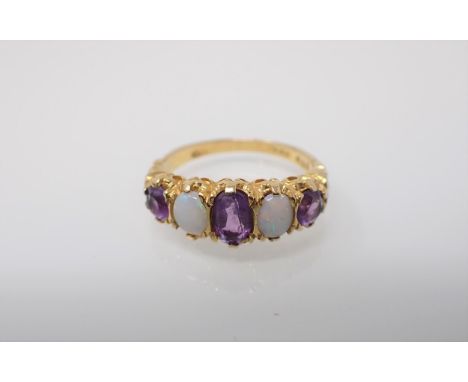 An Amethyst and Opal five stone Ring claw-set oval-cut amethyst between two oval opals and two round amethysts in gold. Ring 