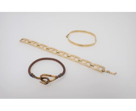 A Hermés leather Bracelet with gilt metal hook and loop clasp, a rigid gilt metal Bangle marked GUCCI and a gilt metal CD lin
