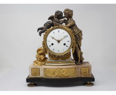 A late 18th Century French gilt metal Mantle Clock flanked and surmounted by classical maiden and putti, with white enamel ci