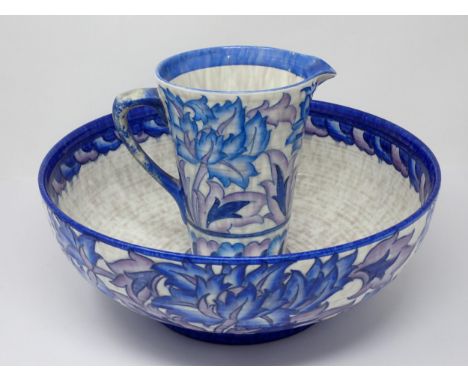 A Charlotte Rhead large Bowl and matching tapering Jug, decorated stylised flowers in blue and purple glazes, Bowl 13in diam,