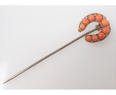 A Coral and Diamond Horseshoe Stick Pin set graduated coral beads with rose-cut diamonds between 