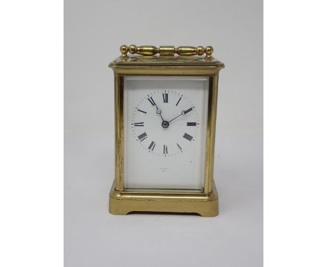 A brass cased Carriage Clock, the enamel dish marked with Roman numerals, name indistinct, 5¼in H 