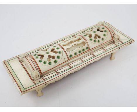 A carved bone Cribbage Board with pierced domed cover containing dominoes and dice, possibly prisoner of war, 9in L