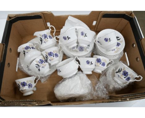 A Royal Windsor bone china tea service comprising twelve teacups, saucers, cake plates, sugar bowl, milk jug, serving plates,