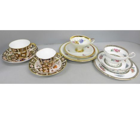 A collection of teacups and saucers including two Royal Crown Derby Imari, one saucer unmarked, Paragon "Tree of Kashmir" tri