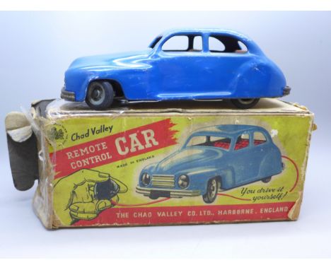 A 1950s Chad Valley remote control car having blue body and red interior. In original box a/f. Pump missing. 