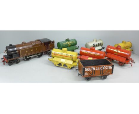 A collection of Hornby 0 gauge model rail comprising of locomotive, six tankers and a wagon.