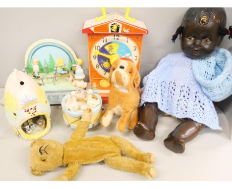 A collection of children's toys includes a Reliable doll, a novelty Teddy bear purse, teaching clock, a 1980's musical box, a