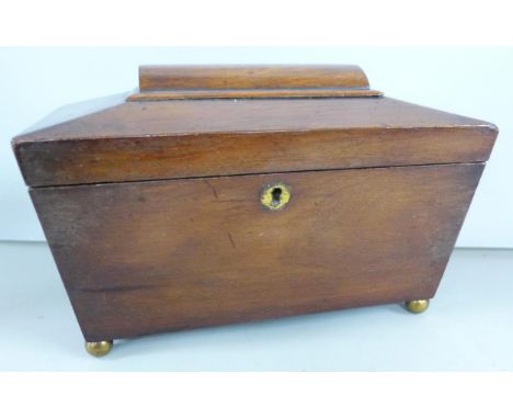 A wooden tea caddy with brass ball feet, lacking key