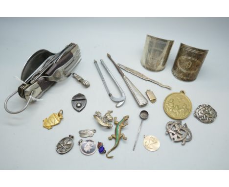 A collection of assorted items including a yellow metal pendant marked 333, 1.8g, a white metal and tortoiseshell pendant wit