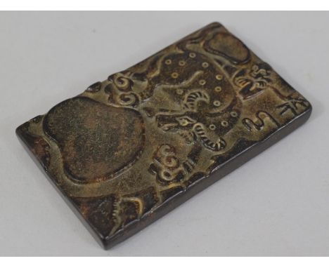 An Oriental Carved Hard Stone rectangular Amulet decorated in Relief with Bull and Figure. 5.5cms Wide, 9cms High