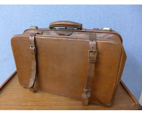 A vintage brown leather Gladstone bag