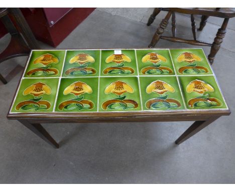 A mahogany occasional table, inset with ten Art Nouveau majolica tiles