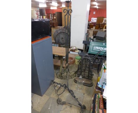 A wrought iron stand, cast iron stick stand and metal hanging light frame