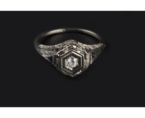 A DIAMOND SINGLE STONE RING, the old-cut diamond in hexagonal setting, above a pierced gallery, white precious metal mounted,