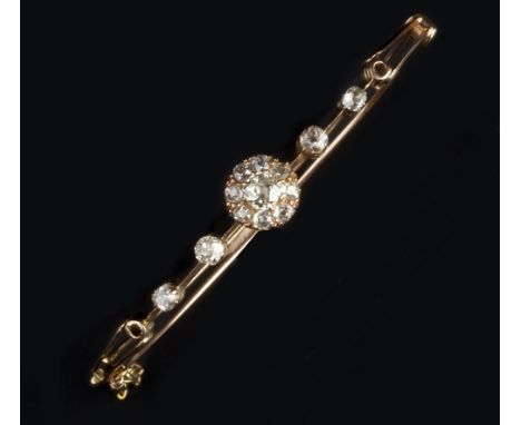 A DIAMOND SET BANGLE, of hinged bifurcated form, centrally set with a cluster of graduated old-cut diamonds, between knife-ed