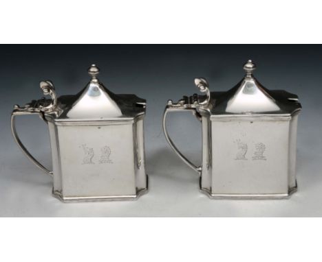 A PAIR OF EDWARDIAN RECTANGULAR SHAPED SILVER MUSTARD POTS with canted corners, domed lids, turned finials and scrolling thum