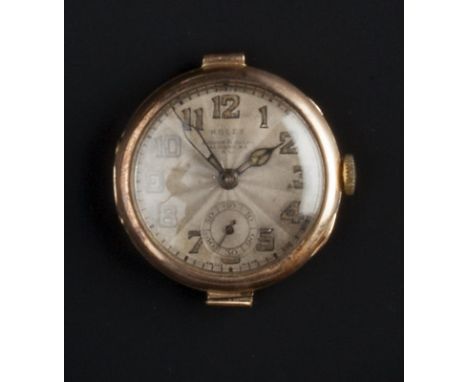 A 9CT GOLD WATCH HEAD BY ROLEX, the circular signed dial with Arabic numerals, subsidiary seconds dial and worn retailer's ma