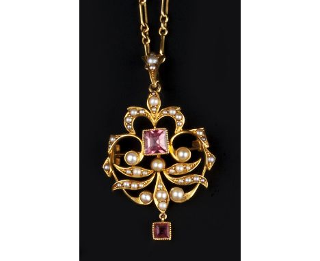 AN EDWARDIAN TOURMALINE AND HALF PEARL PENDANT NECKLACE, the openwork foliate cartouche centred with a square step-cut pink t