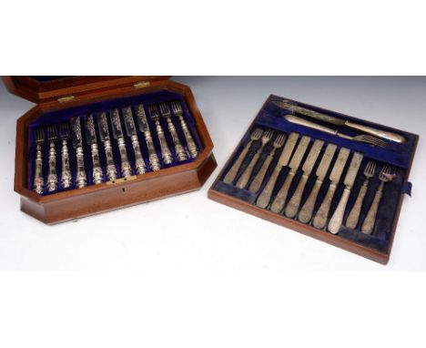 A MAHOGANY CASED SET OF TEA KNIVES AND FORKS with silver blades and filled silver handles, tapering handles with chased scrol