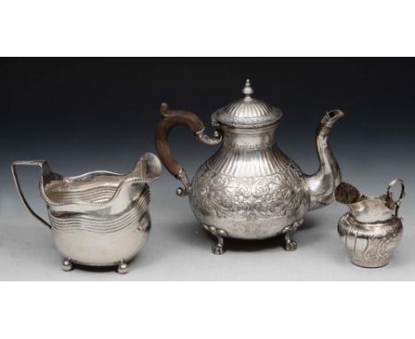 A CONTINENTAL BALUSTER SHAPED TEAPOT with chased foliate and fluted decoration and standing on four legs with pad feet, 17cm 