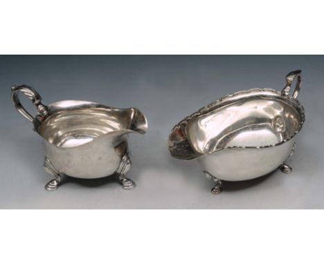 A GEORGE II SILVER SAUCE BOAT of plain form on three cabriole legs with hoof feet, double 'C' scroll handle, 14cm long, Londo