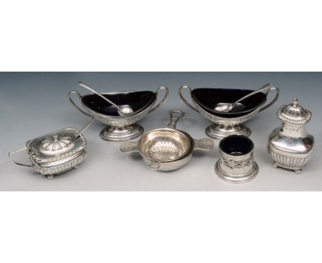 A PAIR OF LATE VICTORIAN OVAL SHAPED TWIN HANDLED SALTS with fluted and engraved decoration and blue glass liners, 12.5cm wid