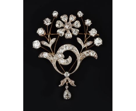A RUSSIAN DIAMOND PANEL BROOCH/PENDANT, the openwork panel centred with a  flowerhead cluster of cushion-shaped old-cut diamo
