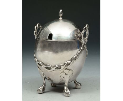 A VICTORIAN SILVER MUSTARD POT in the form of an egg standing on four ball and claw feet with twisted rope style handles and 