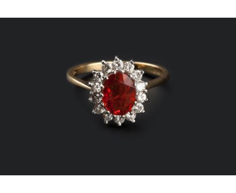 A FIRE OPAL AND DIAMOND CLUSTER RING, the oval mixed-cut fire opal claw set within a border of round brilliant-cut diamonds, 