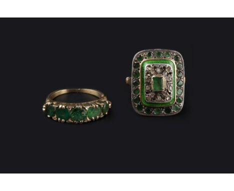 TWO EMERALD DRESS RINGS, the first a rectangular panel ring, highlighted with green enamel and lasque-cut diamonds, two colou