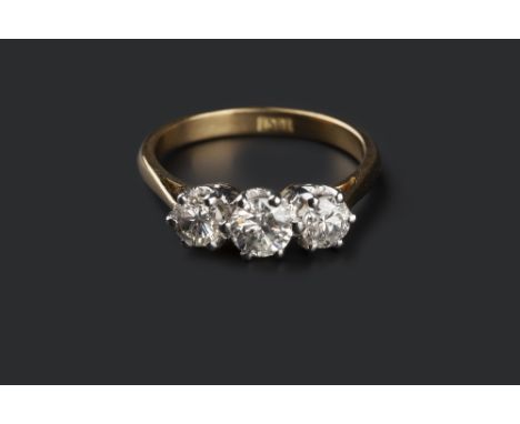 A DIAMOND THREE STONE RING, the round brilliant-cut diamonds in claw setting, to shank stamped '18ct', total diamond weight a