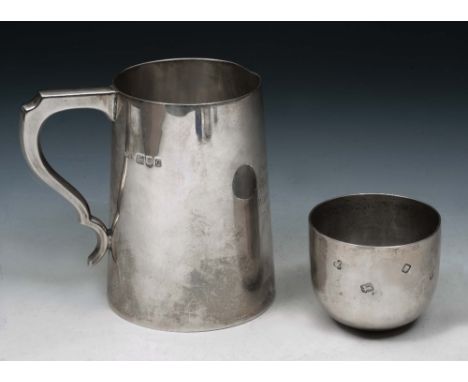 A PLAIN SILVER TANKARD of tapering form with double 'C' scroll handle, 12cm high, London 1942 by Ollivant & Botsford; and a p