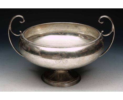 A GEORGE V SILVER PUNCH BOWL with scroll and bead decorated edge, two scrolled handles and a turned stepped foot, 32cm wide, 