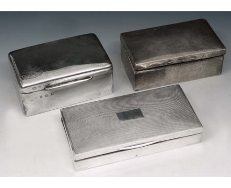 A SILVER CEDAR LINED CIGARETTE BOX with engine turned decoration, 17.2cm long, London 1935 by Alfred Ernest Neighbour; and tw