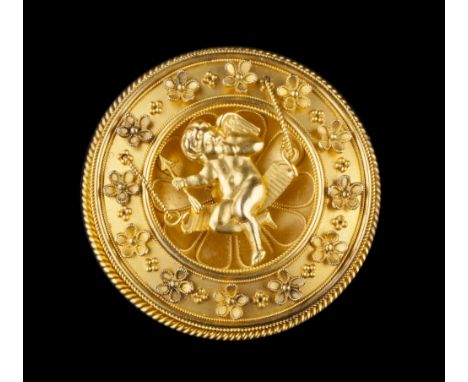 AN ARCHAEOLOGICAL REVIVAL GOLD PANEL BROOCH, the circular concave panel depicting cupid seated on a swing and clutching a gol