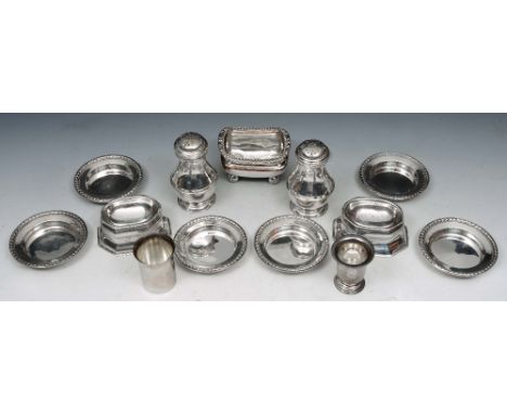 A PAIR OF SILVER BALUSTER SHAPED PEPPERS with pierced press on lids and standing on turned stepped feet, 9.5cm high, London 1